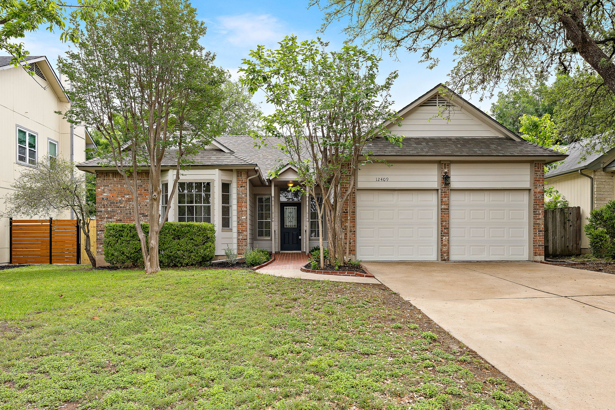 12409 Hunters Chase Drive Austin, TX 78729 - Photo 1 of 1 a front view of a house with a yard and garage