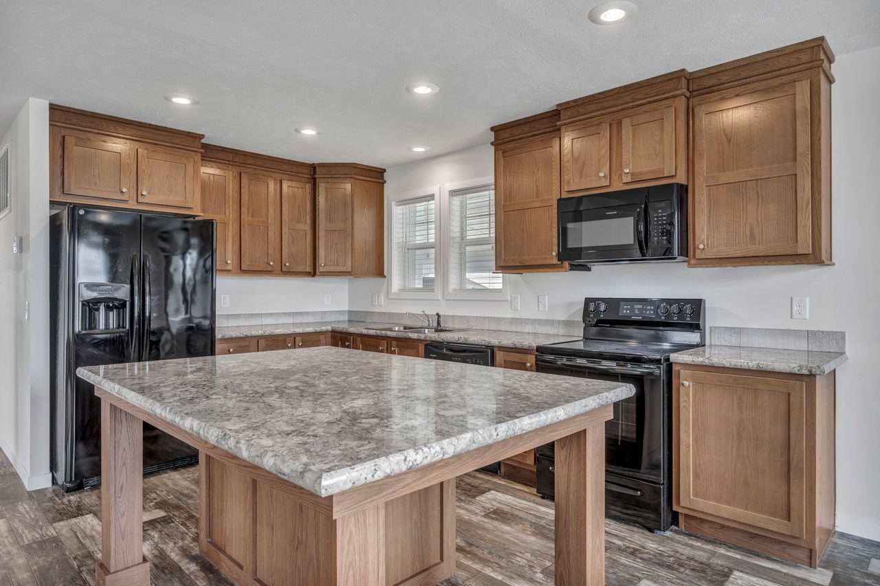 1067 Richard Road Elgin, IL 60123 - Photo 10 of 18 a kitchen with stainless steel appliances granite countertop a sink microwave and stove