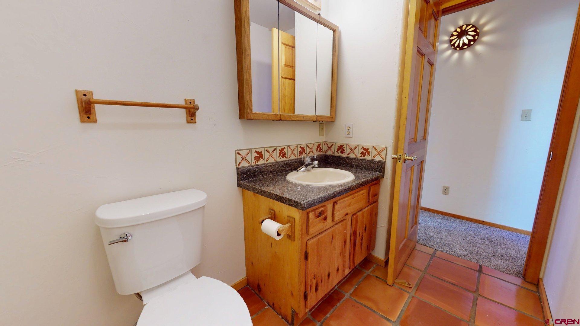 40557 M75 Road Paonia, CO 81428 - Photo 16 of 34 a bathroom with a sink a toilet and mirror