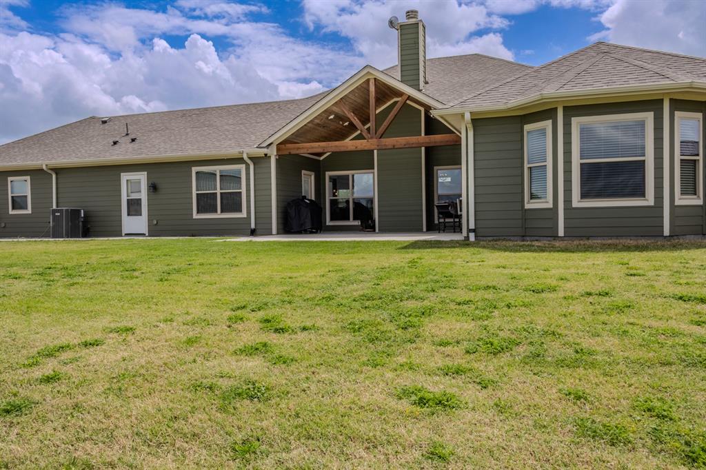 14910 Old Stoney Road Ponder, TX 76259 - Photo 34 of 36 a view of a house with a yard
