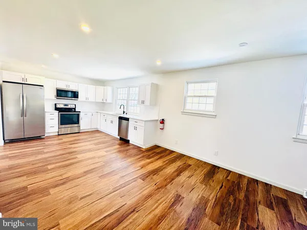 a room with a bed furniture and kitchen view