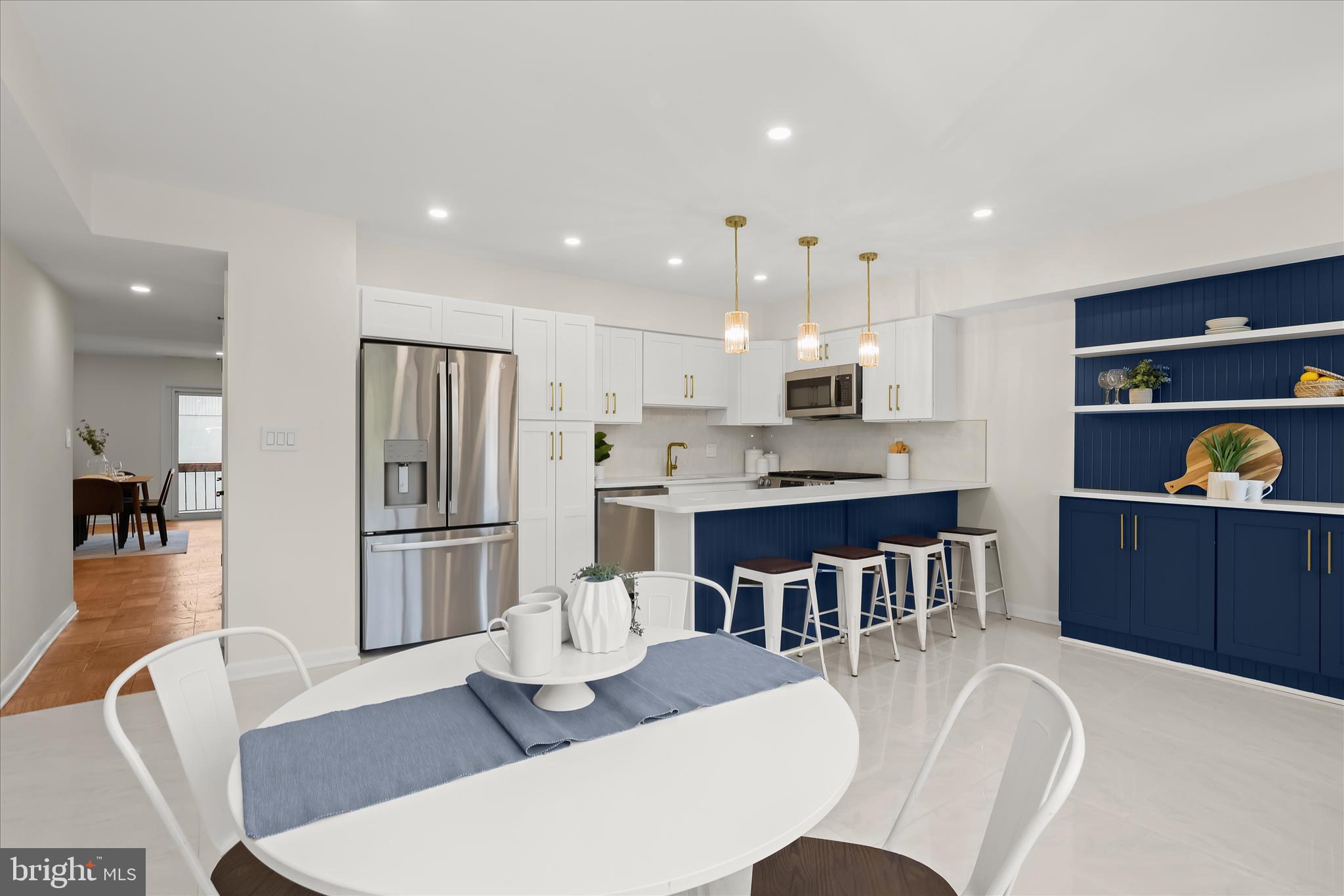 a large kitchen with a table and chairs