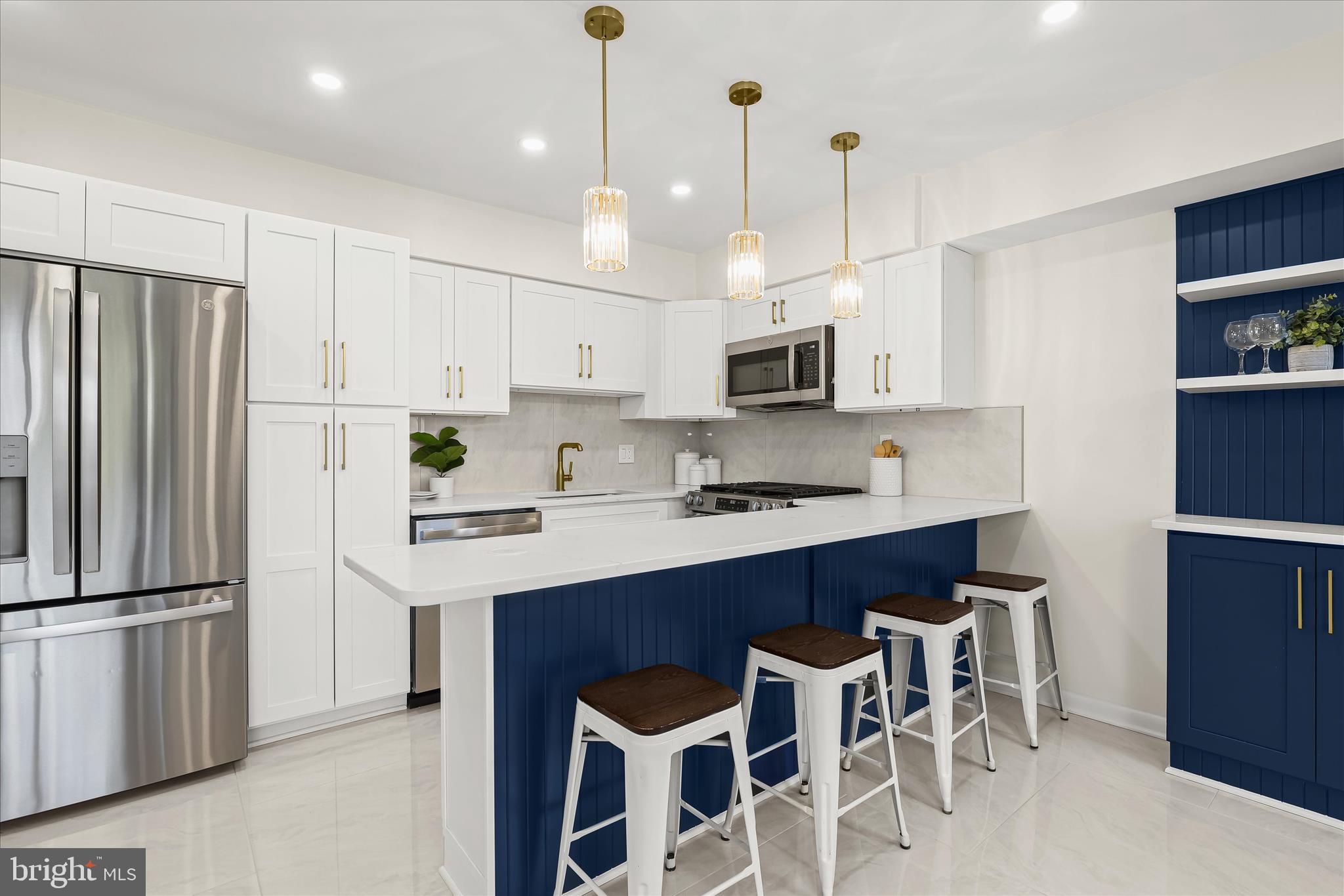 2 Cross Keys Road, Unit 2F Baltimore, MD 21210 - Photo 12 of 36 a kitchen with stainless steel appliances granite countertop a refrigerator a sink dishwasher a stove and a refrigerator with wooden floor