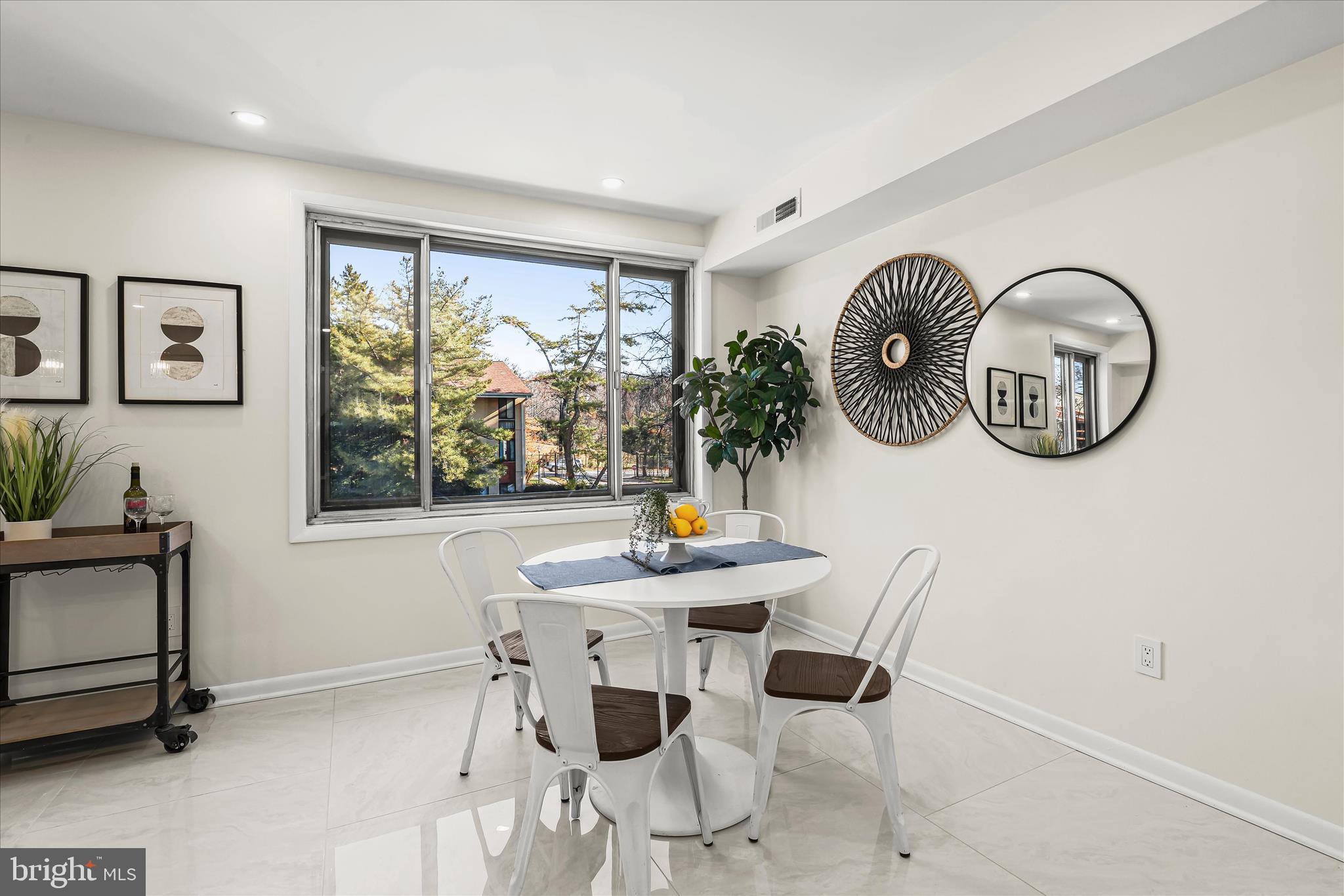 2 Cross Keys Road, Unit 2F Baltimore, MD 21210 - Photo 16 of 36 a view of a dining room with furniture and a large window