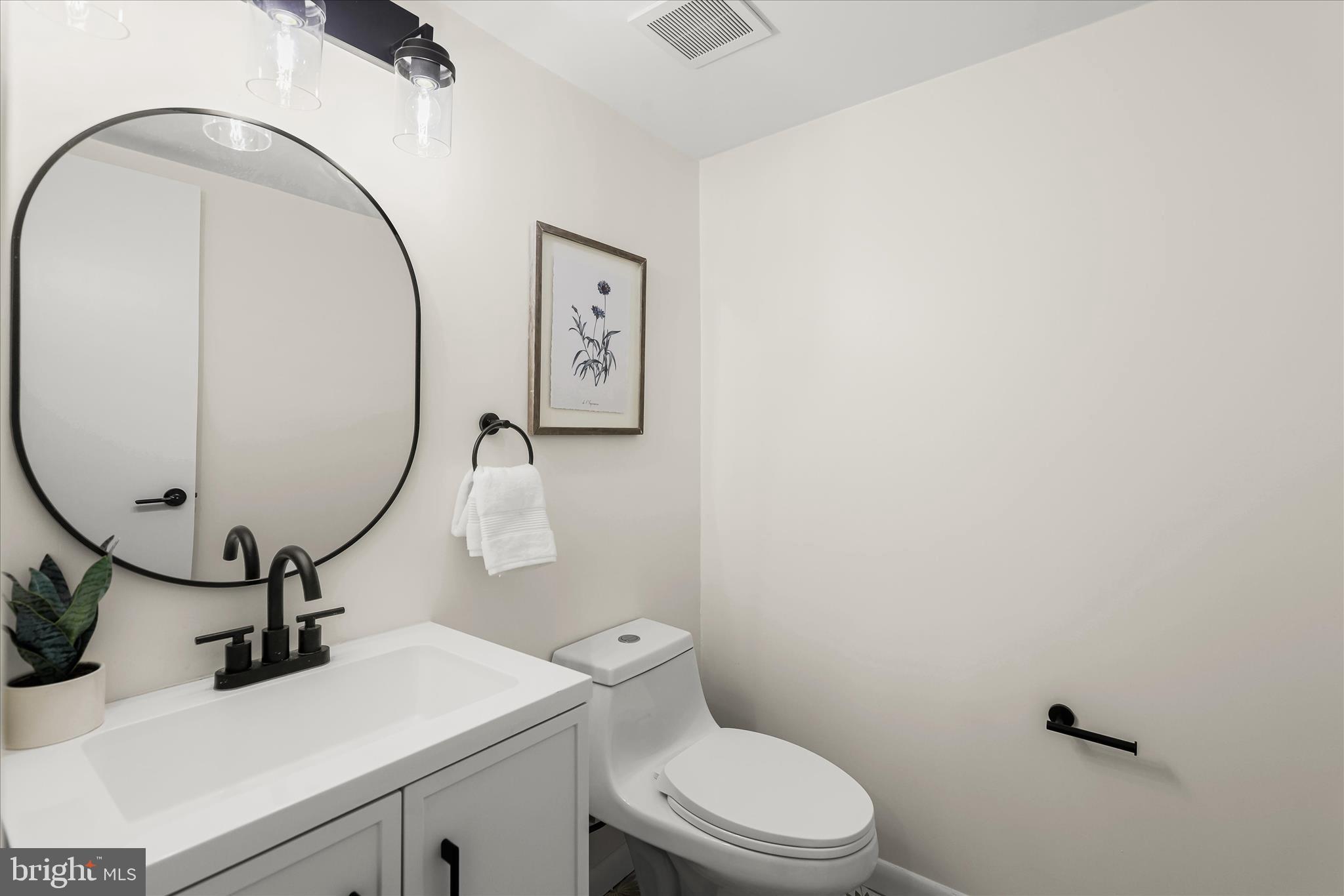 2 Cross Keys Road, Unit 2F Baltimore, MD 21210 - Photo 17 of 36 a bathroom with a sink mirror and toilet