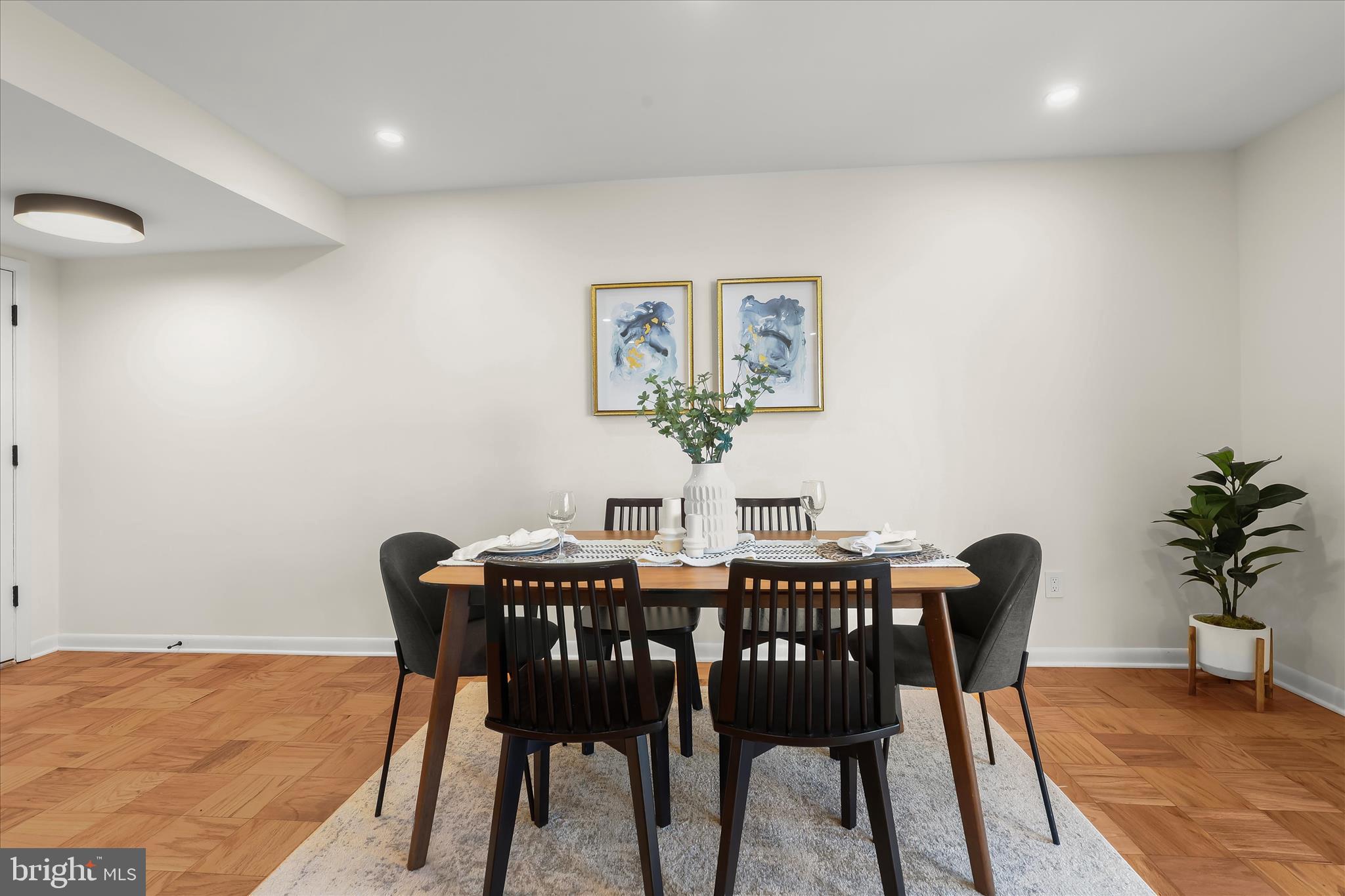 2 Cross Keys Road, Unit 2F Baltimore, MD 21210 - Photo 7 of 36 a view of a dining room with furniture and wooden floor