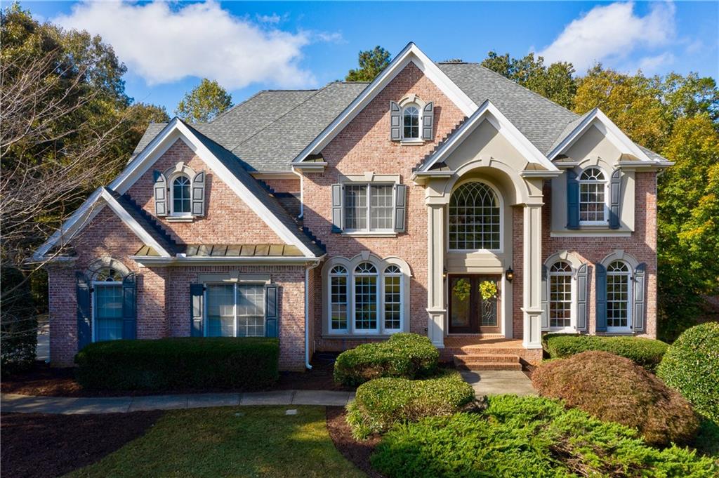 Love the curb appeal of this stunning brick home on an acre lot with pool in Litchfield Hundred Swim/Tennis in Roswell. 