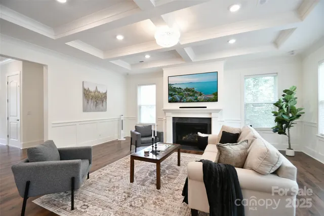 a living room with furniture a fireplace and a potted plant