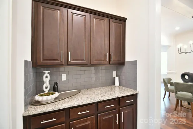 a kitchen with granite countertop stainless steel appliances a sink and cabinets