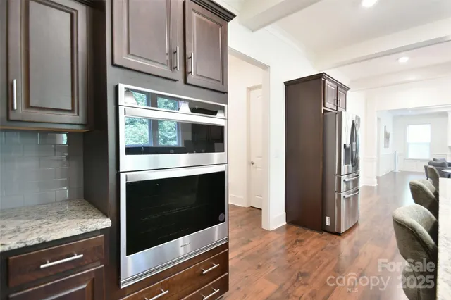 a kitchen with granite countertop cabinets and steel stainless steel appliances