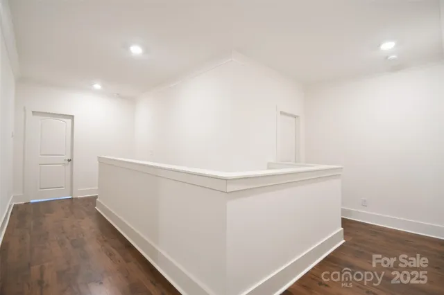a view of hallway with wooden floor