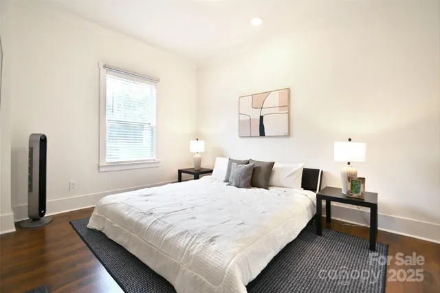 a bedroom with a bed and a night stand