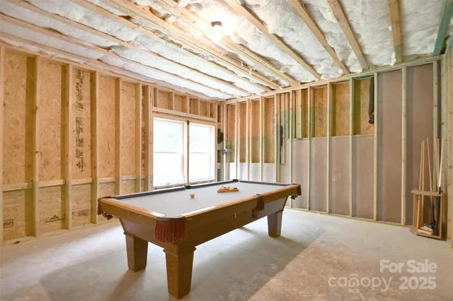 a room with pool table and furniture
