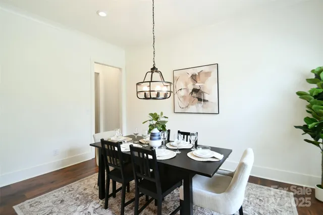 a view of a dining room with a table and chairs
