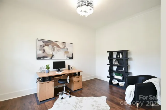 a view of a workspace with furniture and wooden floor