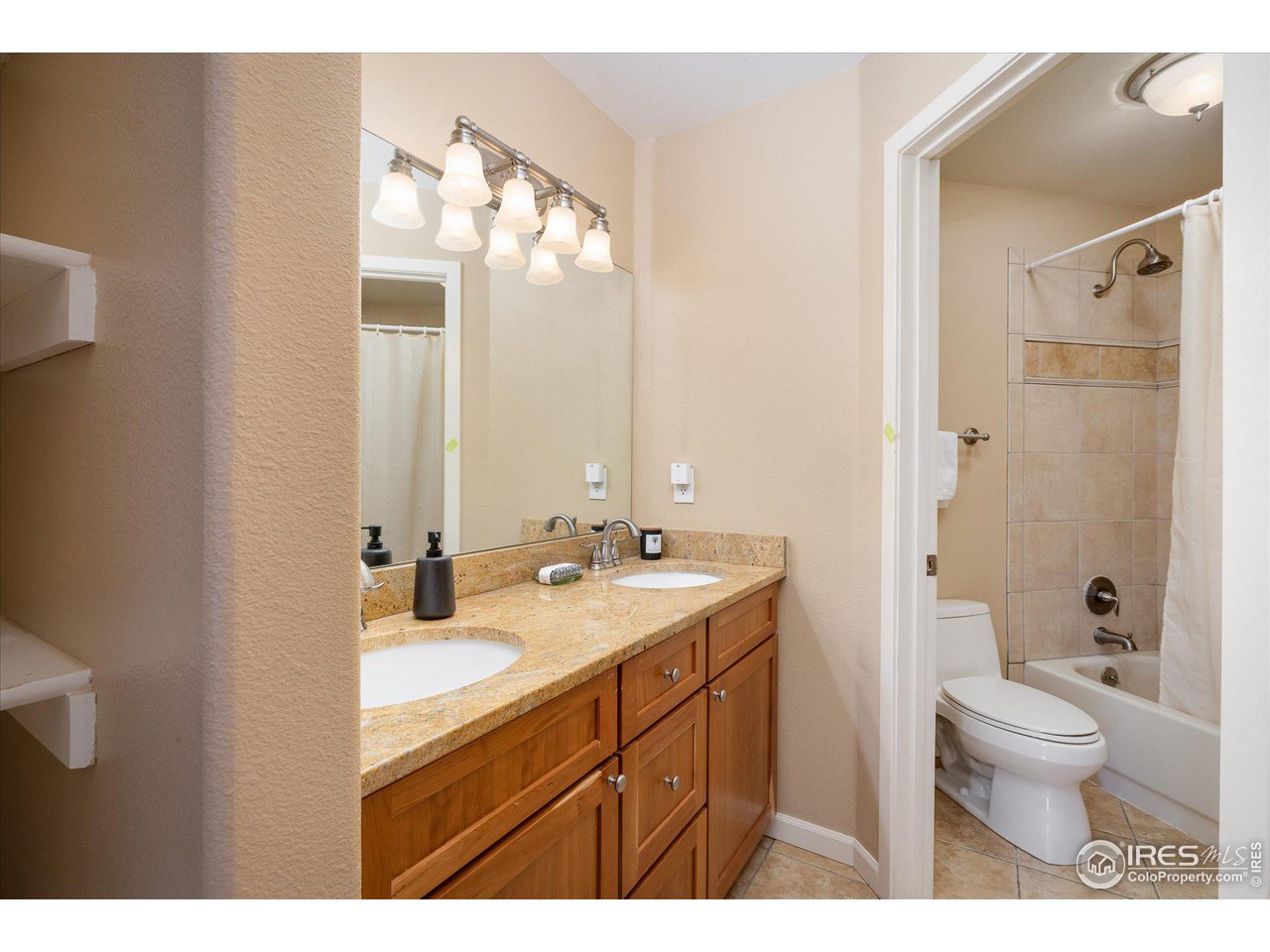 5251 Olde Stage Road Boulder, CO 80302 - Photo 25 of 39 a bathroom with a double vanity sink toilet mirror and shower