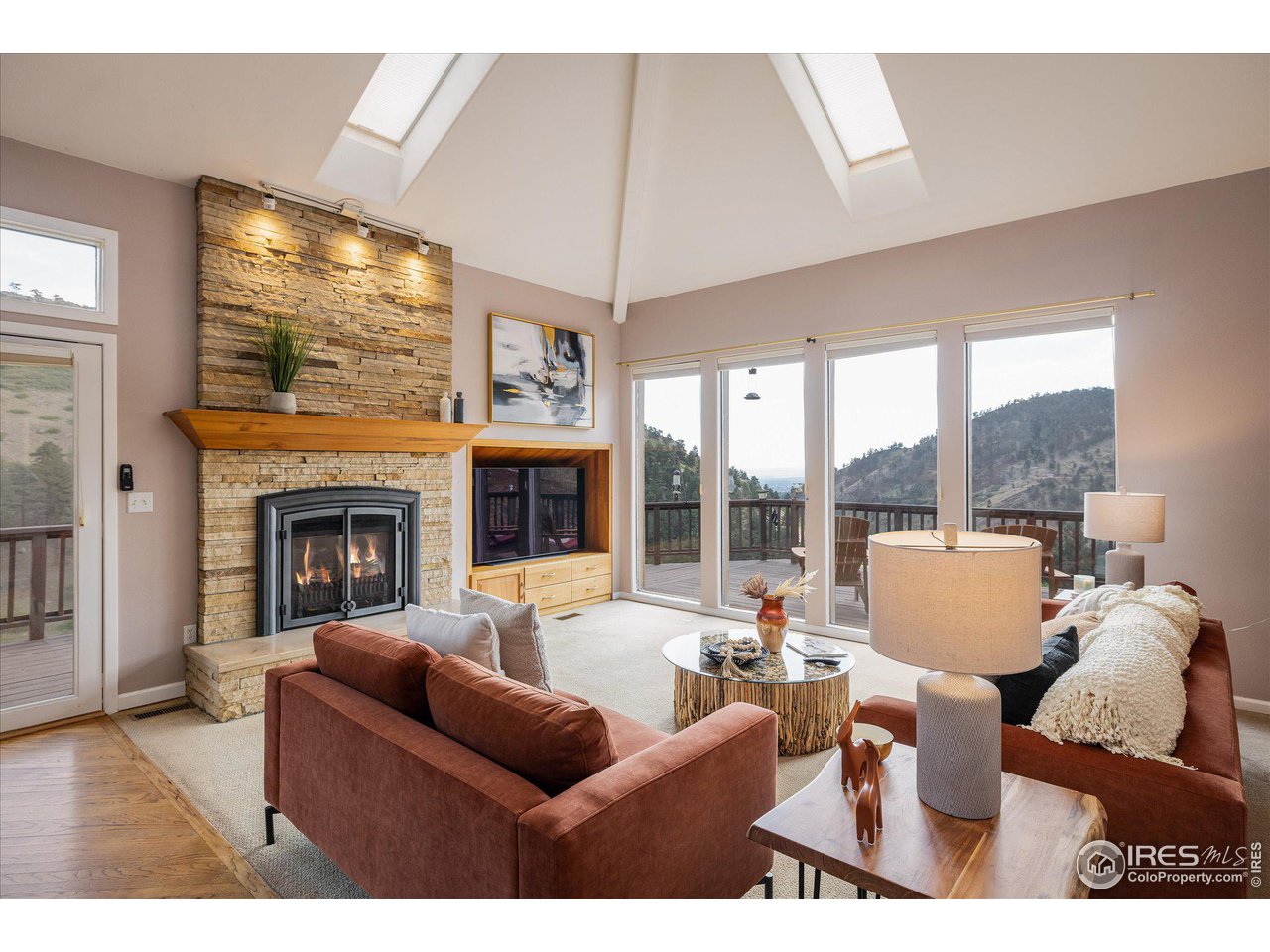 5251 Olde Stage Road Boulder, CO 80302 - Photo 6 of 39 a living room with furniture a large window and a fireplace