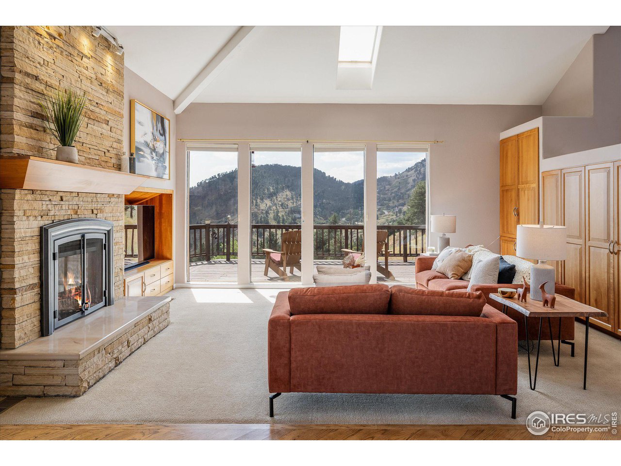 5251 Olde Stage Road Boulder, CO 80302 - Photo 7 of 39 a living room with furniture a large window and a fireplace