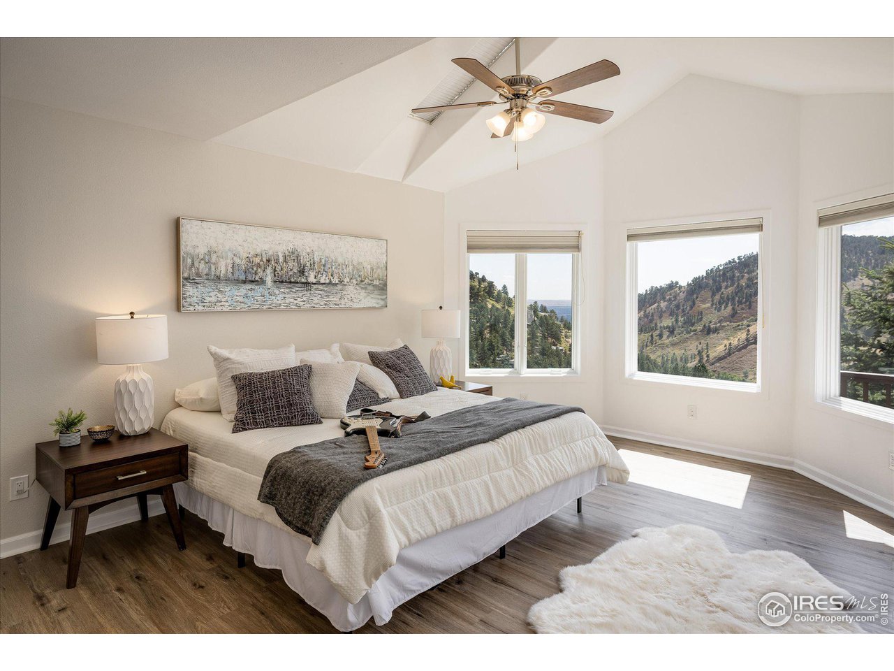 5251 Olde Stage Road Boulder, CO 80302 - Photo 8 of 39 a spacious bedroom with a bed a couch and large window