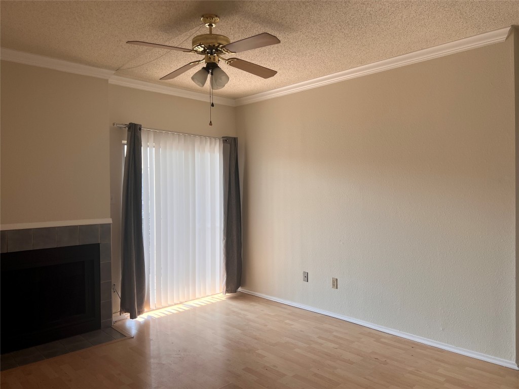 12166 Metric Boulevard, Unit 3007 Austin, TX 78758 - Photo 3 of 19 an empty room with a chandelier fan and windows