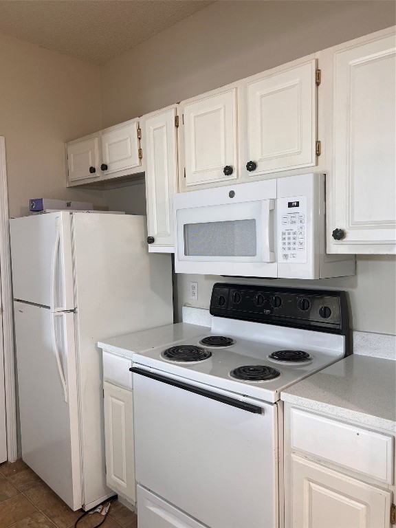 12166 Metric Boulevard, Unit 3007 Austin, TX 78758 - Photo 8 of 19 a white refrigerator freezer and a stove sitting inside of a kitchen with granite countertop white cabinets