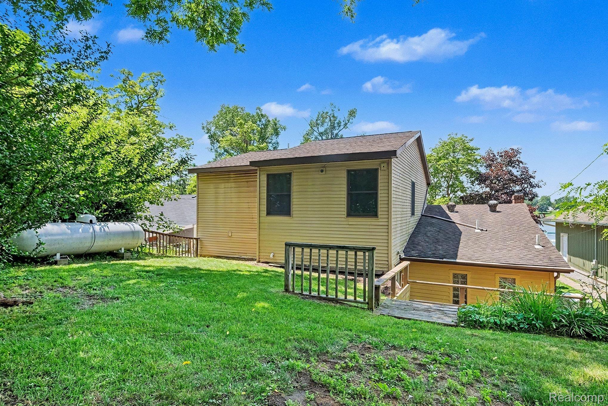 16059 Murray Road Byron, MI 48418 - Photo 24 of 32 Exterior with horizontal siding and a dark shingle roof