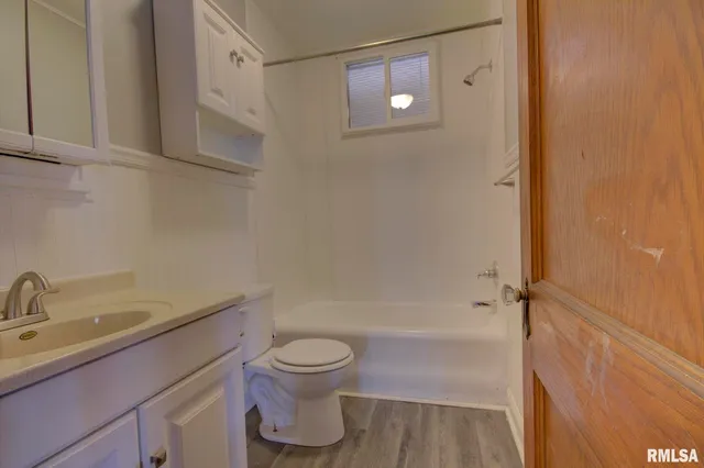 a kitchen with a refrigerator sink and cabinets
