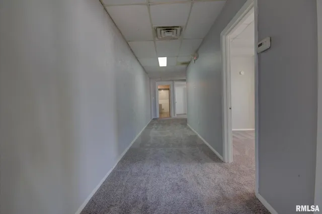 a view of an empty room and a window