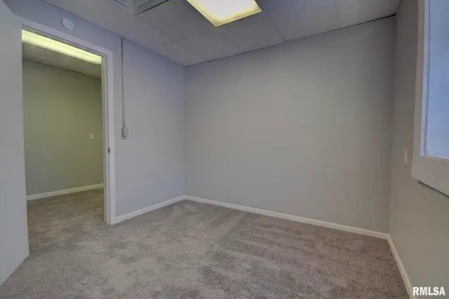 a view of a kitchen with a sink a refrigerator cabinets and wooden floor