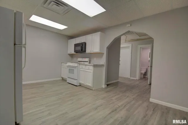 a kitchen with a refrigerator and a sink