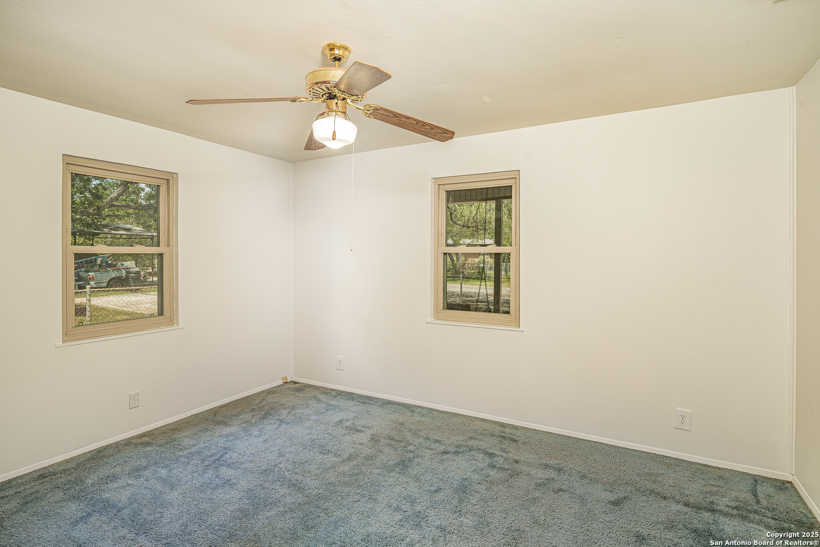 611 Austin Street Sabinal, TX 78881 - Photo 12 of 45 an empty room with a window and a fan
