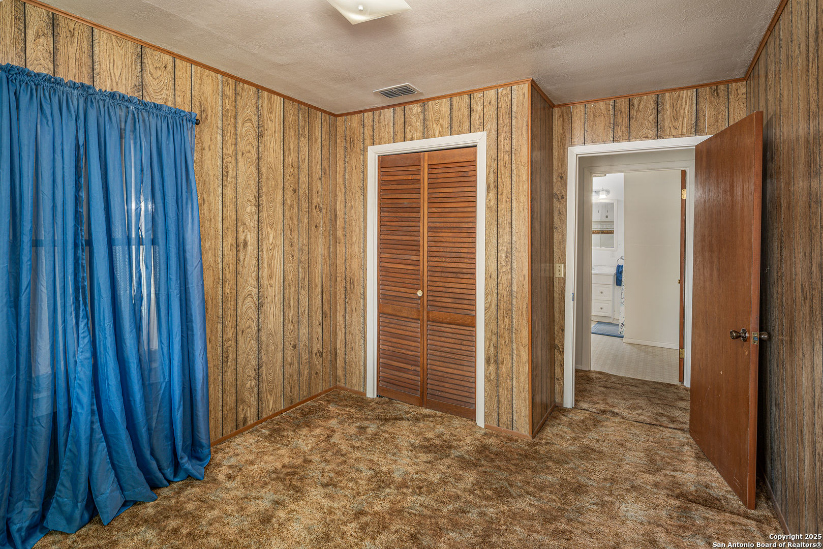 611 Austin Street Sabinal, TX 78881 - Photo 16 of 45 a view of entryway with wooden walls