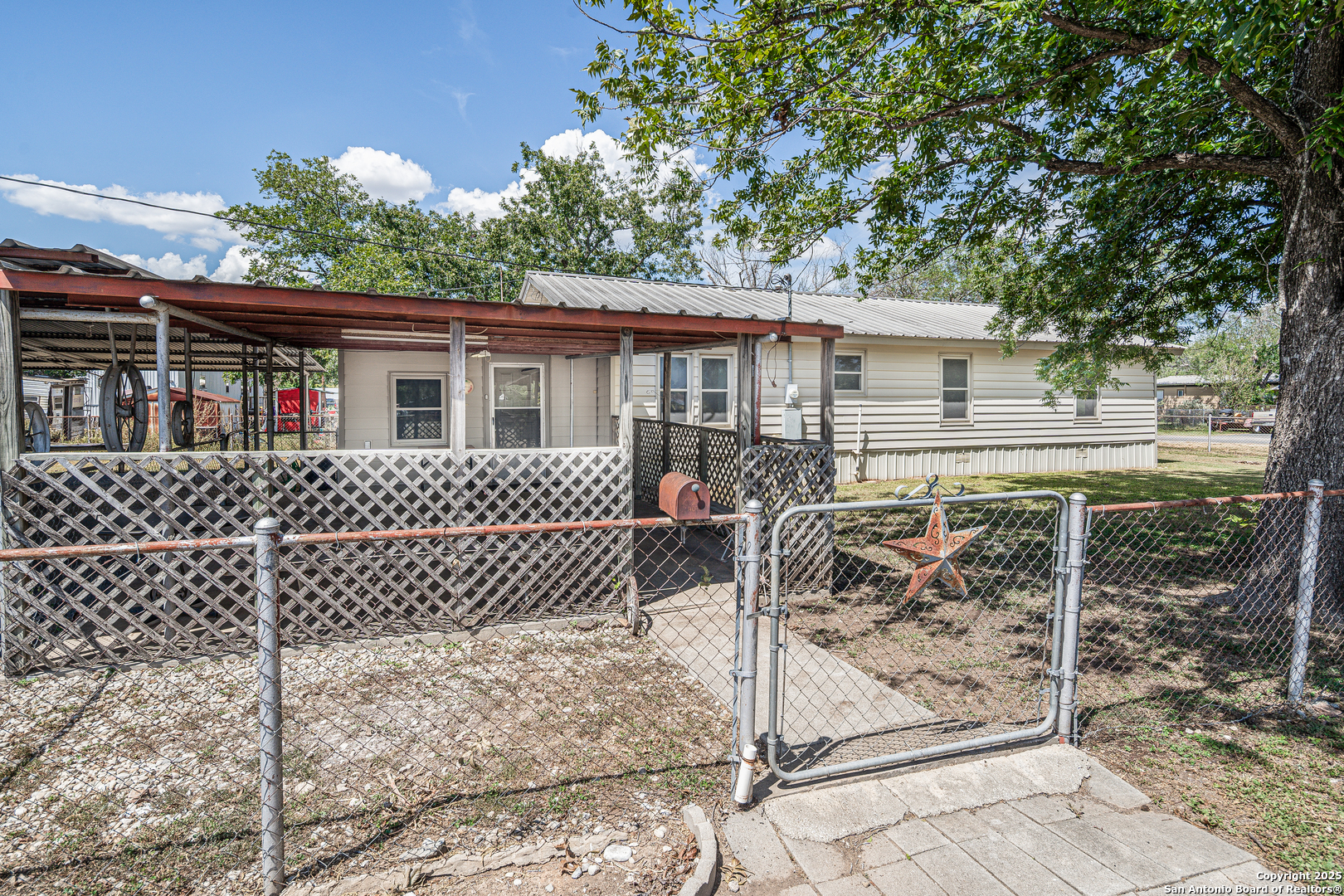 611 Austin Street Sabinal, TX 78881 - Photo 28 of 45 a view of a house with a bench
