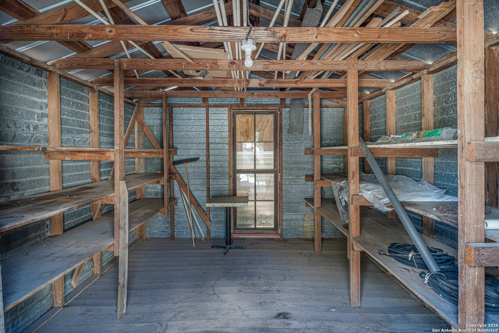 611 Austin Street Sabinal, TX 78881 - Photo 34 of 45 a view of an empty room with wooden floor and stairs