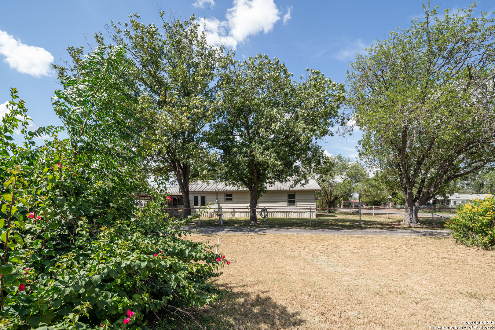 611 Austin Street Sabinal, TX 78881 - Photo 44 of 45 a view of house with yard and outdoor seating