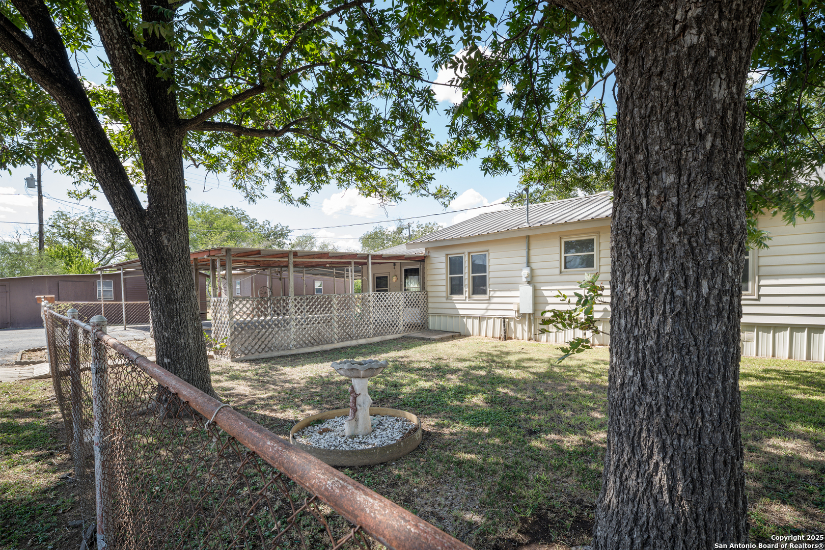 611 Austin Street Sabinal, TX 78881 - Photo 45 of 45 a view of a house with backyard and sitting area
