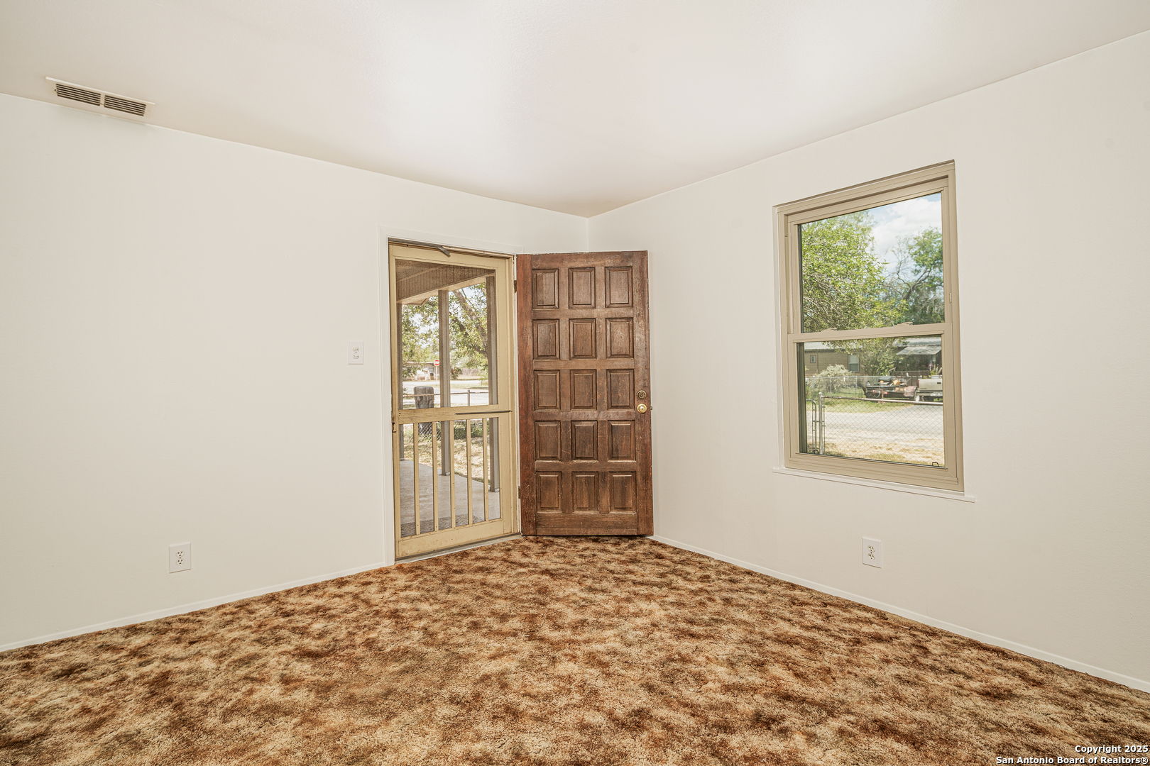 611 Austin Street Sabinal, TX 78881 - Photo 6 of 45 a view of an empty room with a window