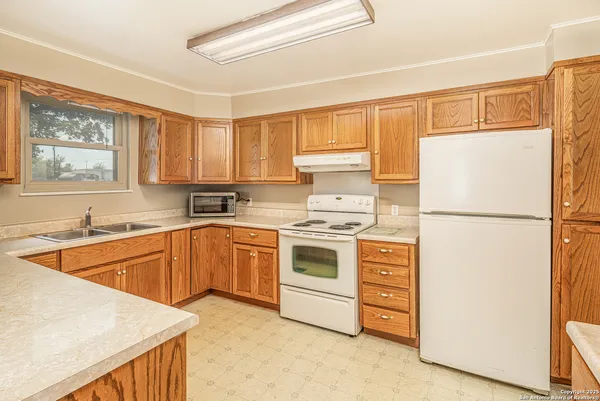 a kitchen with stainless steel appliances granite countertop a refrigerator sink and cabinets