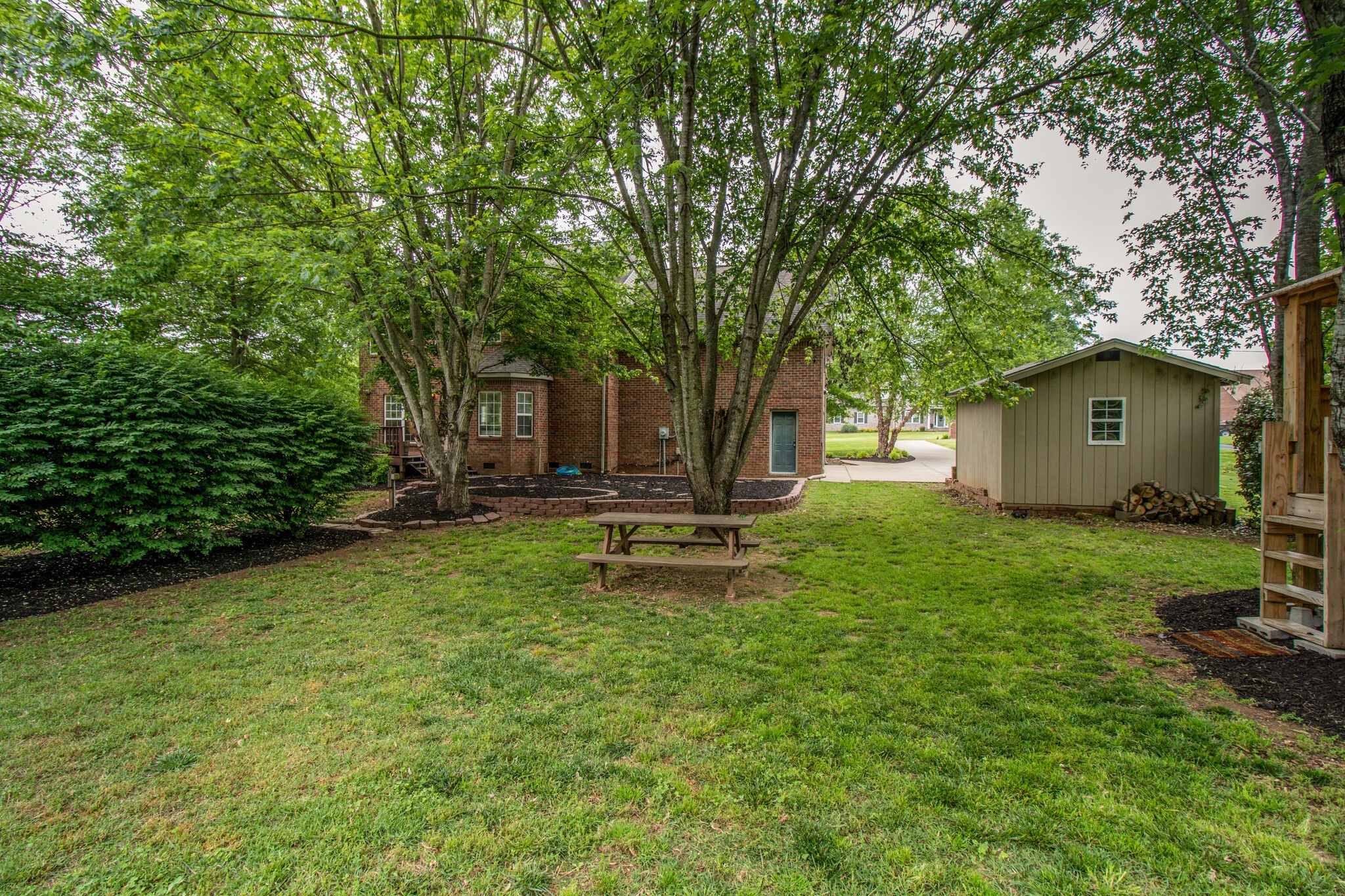1933 Victorian Road Columbia, TN 38401 - Photo 18 of 20 a view of a backyard with a garden and trees