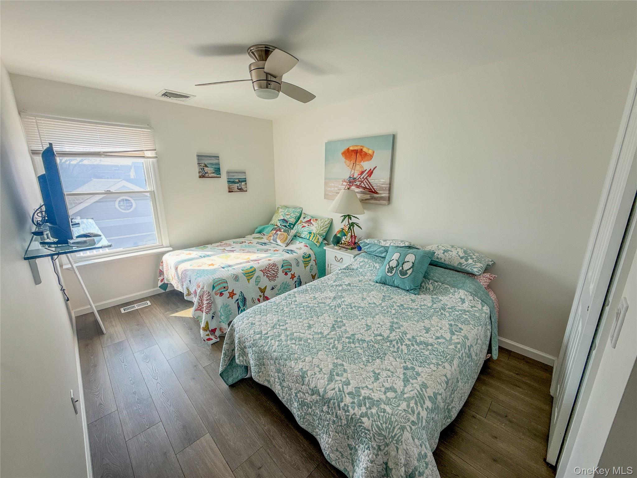 97 Cedarhurst Avenue Point Lookout, NY 11569 - Photo 14 of 21 a bedroom with two beds and painting on the wall