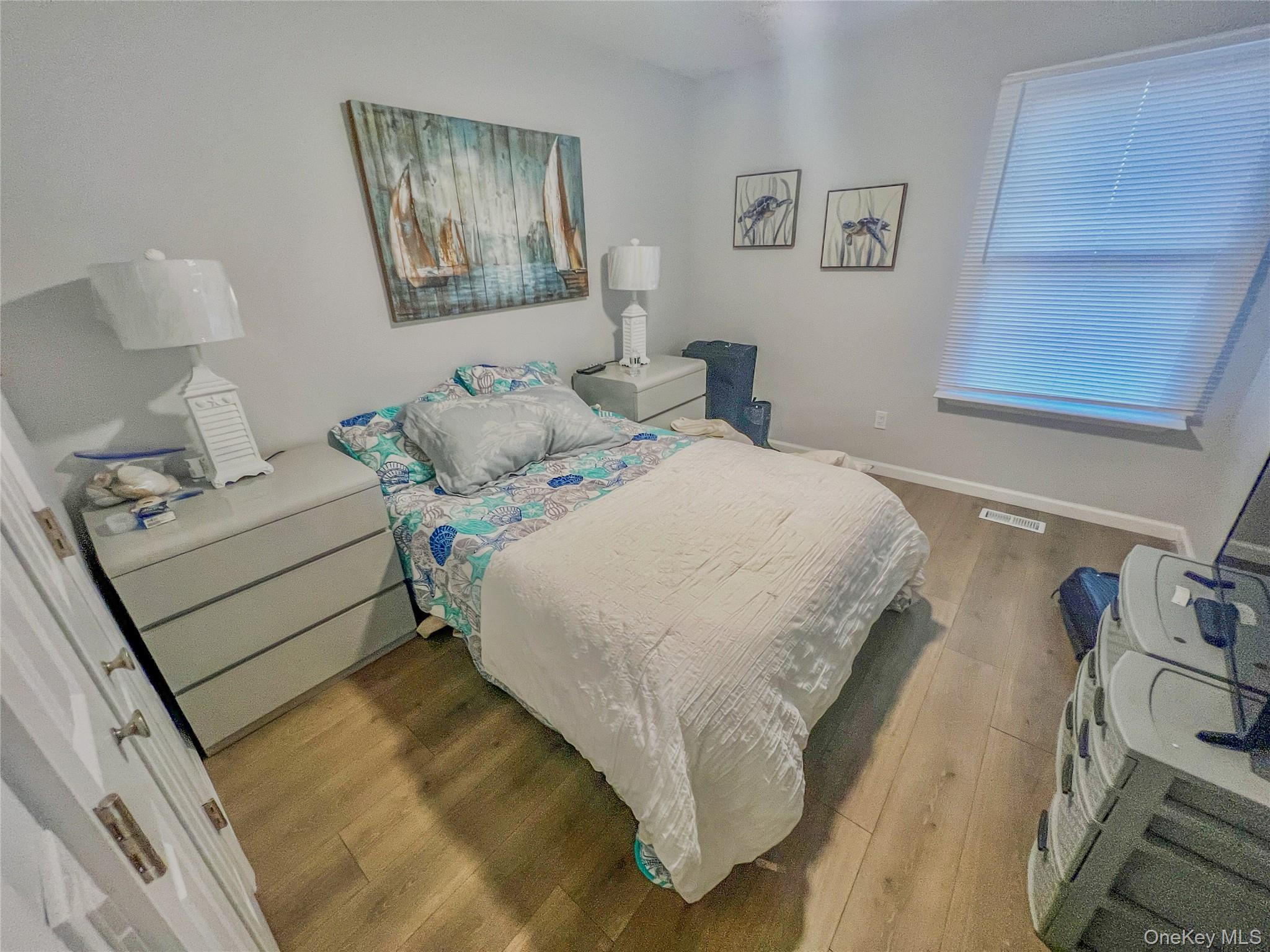 97 Cedarhurst Avenue Point Lookout, NY 11569 - Photo 15 of 21 a bedroom with a bed and wooden floor