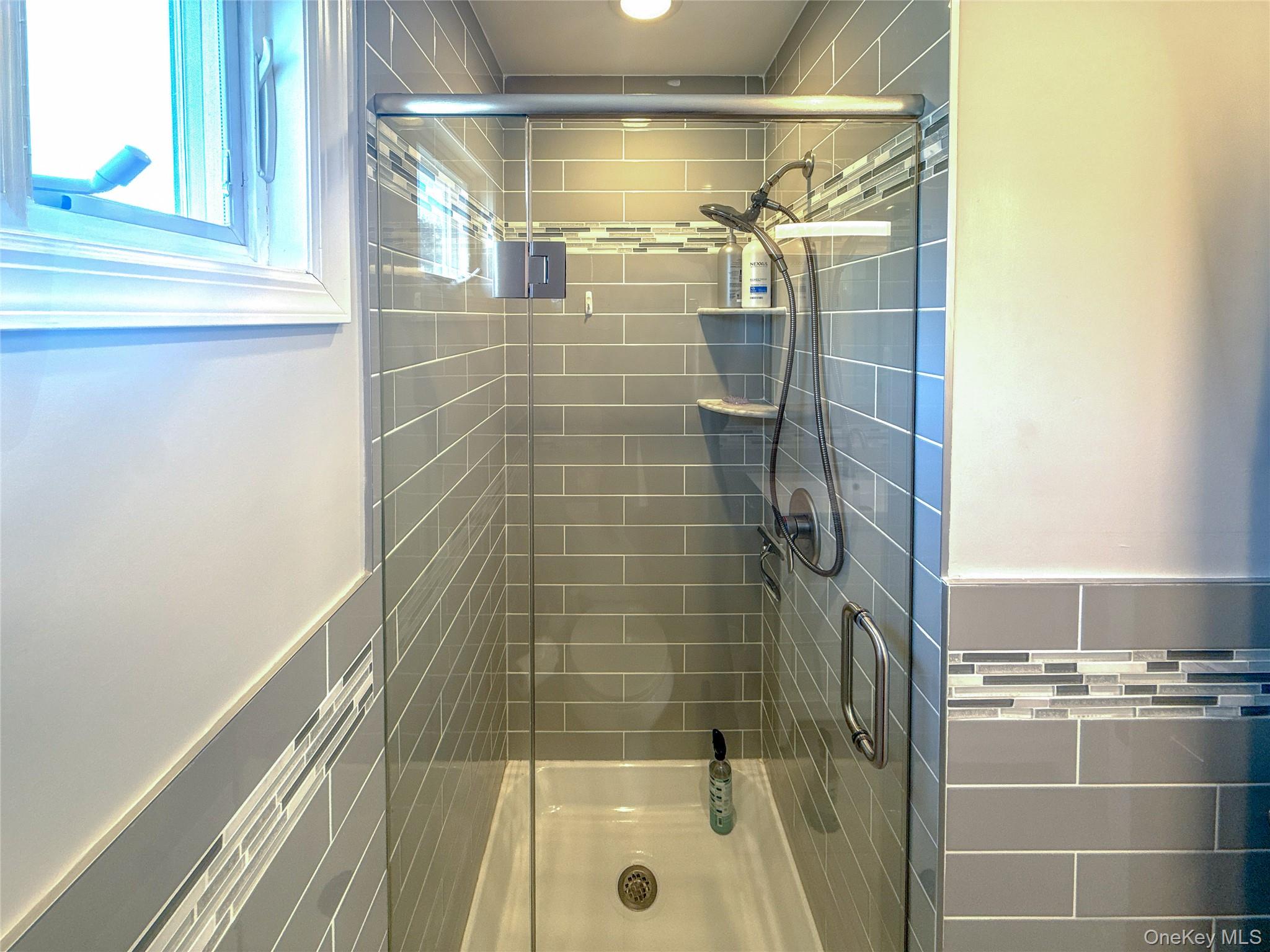 97 Cedarhurst Avenue Point Lookout, NY 11569 - Photo 17 of 21 a bathroom with a shower