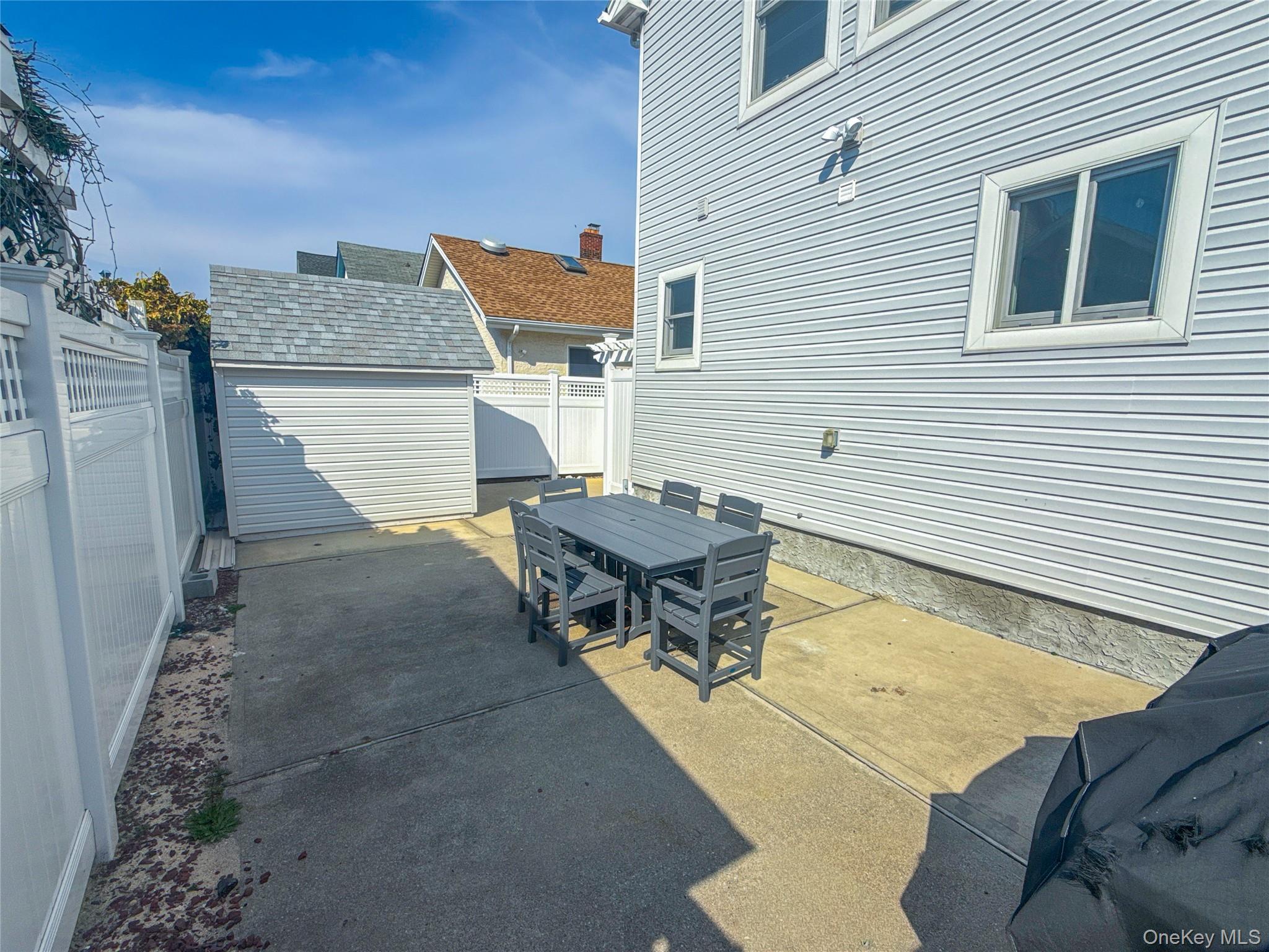 97 Cedarhurst Avenue Point Lookout, NY 11569 - Photo 20 of 21 a roof deck with table and chairs