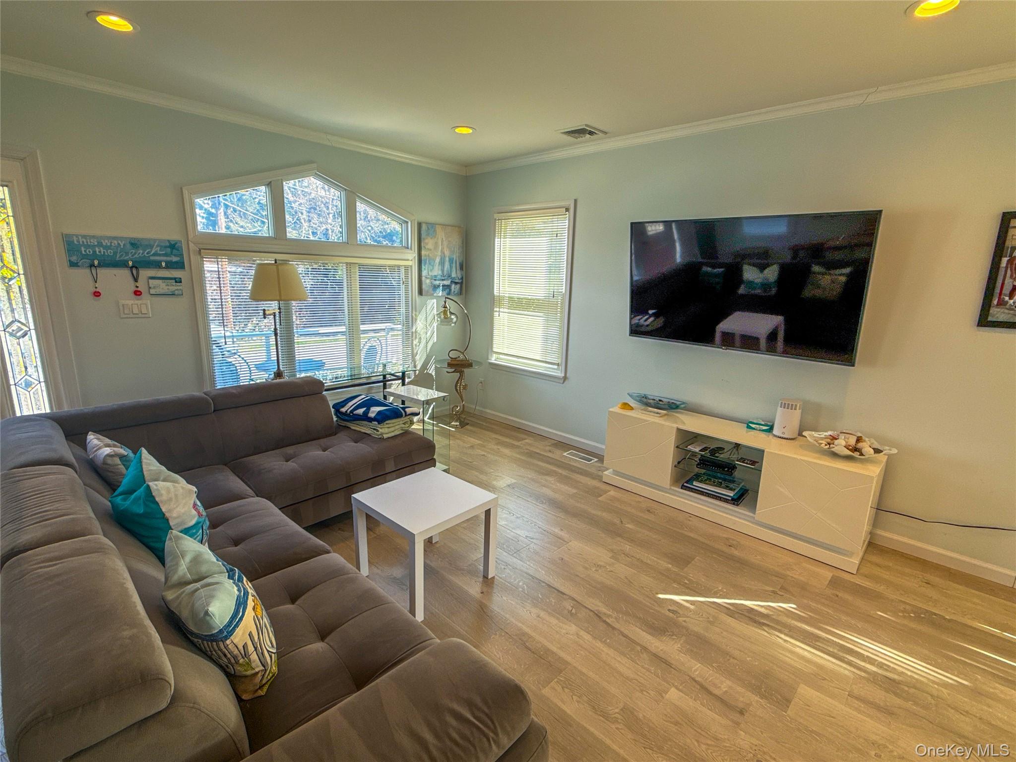 97 Cedarhurst Avenue Point Lookout, NY 11569 - Photo 4 of 21 a living room with furniture and a flat screen tv