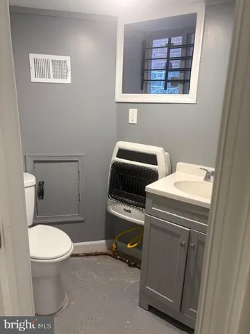 a bathroom with a toilet and a vanity