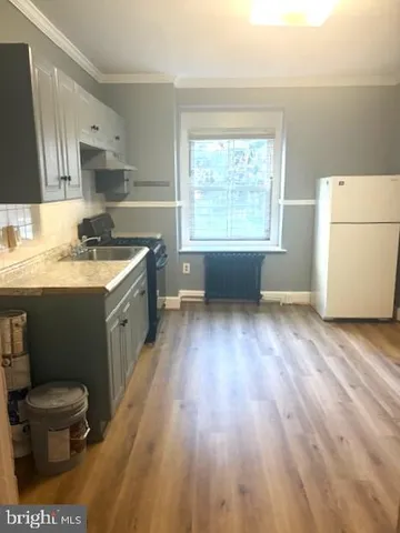 a kitchen with a sink a stove a refrigerator and a stove