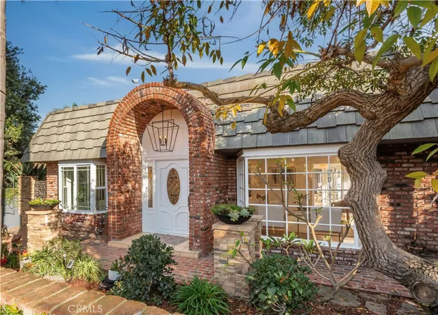 a front view of a house with a garden