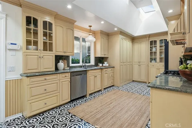 a kitchen with granite countertop a sink stove and cabinets