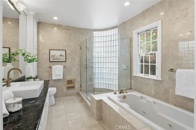a spacious bathroom with a bathtub sink and toilet