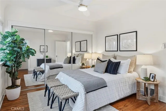 a bedroom with bed and a potted plant